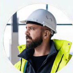 Kevin Debnam wearing a white hard hat and hi-vis jacket
